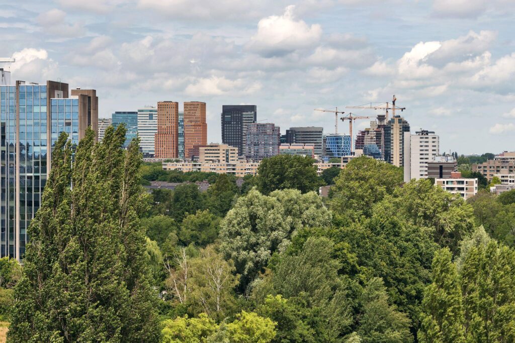 View of modern high-rise buildings along Prof. W.H. Keesomlaan in Amstelveen, seen from a green park area.